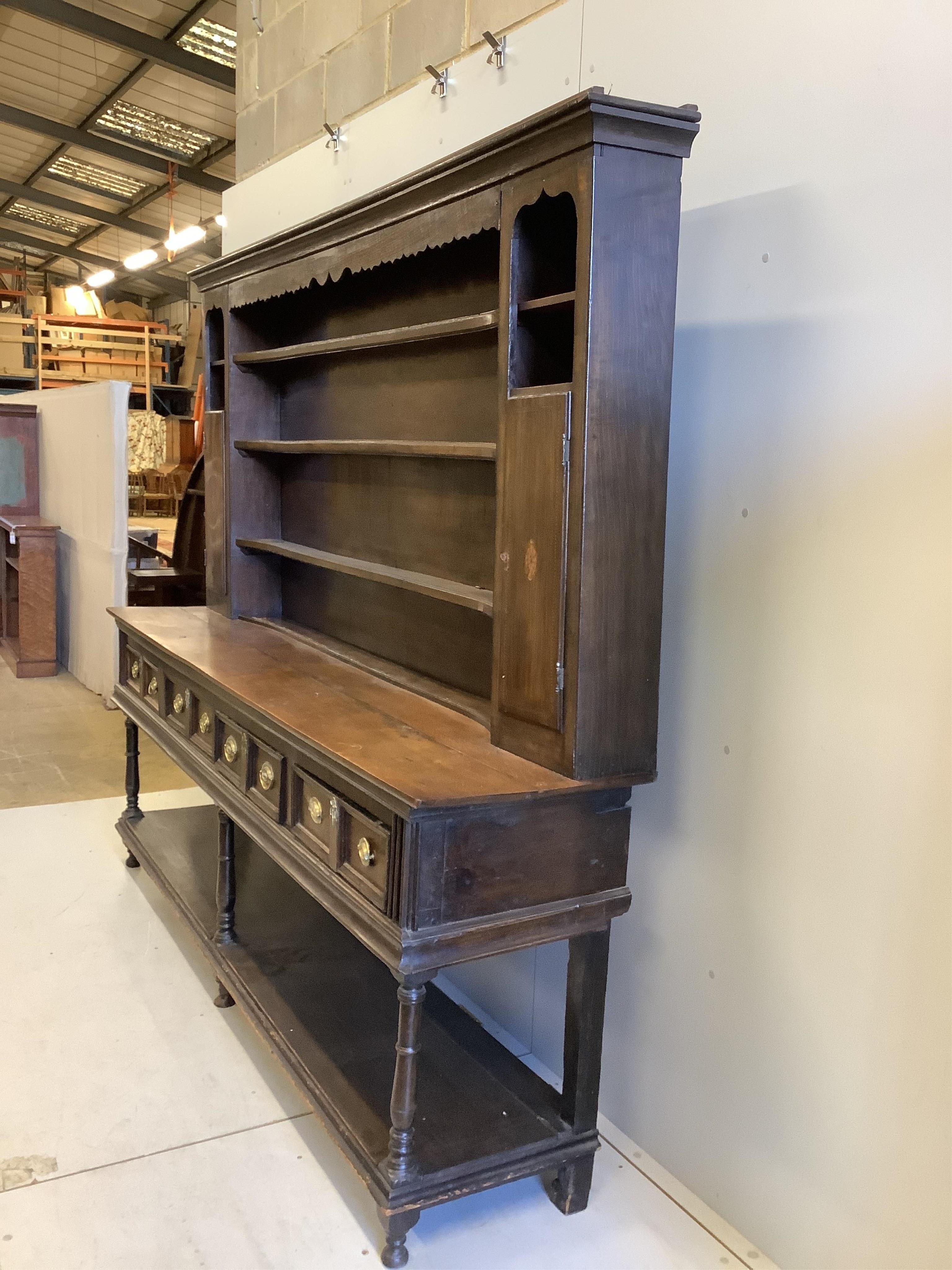 A George III oak pot board dresser with associated boarded rack, width 234cm, depth 49cm, height 197. Condition - fair